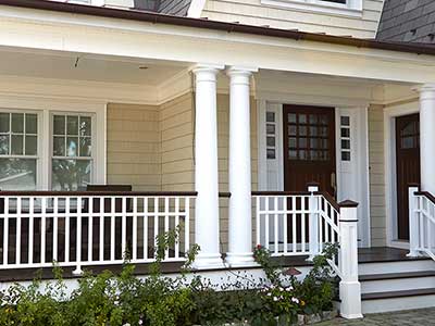 Residential front porch with beige CertainTeed siding