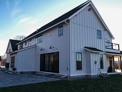 Side view of a mid-class home with white James Hardie siding