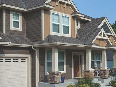 Front view of a mid-class home with brown LP SmartSide siding