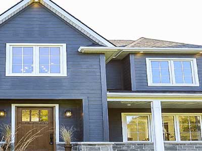 Front view of a mid-class home with Royal blue siding